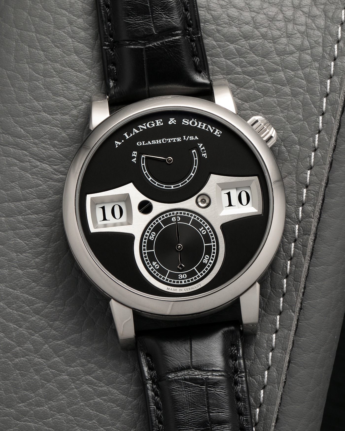 Brand: A. Lange & Söhne
Year: 2014
Model: Zeitwerk
Reference Number: 140.029
Material: 18-carat White Gold
Movement: A. Lange & Söhne Cal. L043.1, Manual-Winding
Case Dimensions: 41.9mm x 12.9mm (49.9mm Lug-to-Lug)
Lug Width: 20mm
Strap: A. Lange & Söhne Black Alligator Strap with Signed 18-carat White Gold Tang Buckle