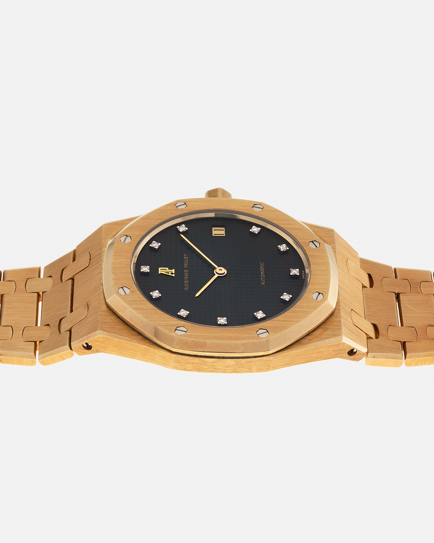 Brand: Audemars Piguet
Year: 1980’s
Model: Royal Oak
Reference Number: 5402BA
Serial Number: 5XX
Material: 18-carat Yellow Gold
Movement: Audemars Piguet Cal. 2121, Self-Winding
Case Dimensions: 39mm x 48mm (Including Lugs) x 7mm
Bracelet: Audemars Piguet Integrated Bracelet in 18-carat Yellow Gold