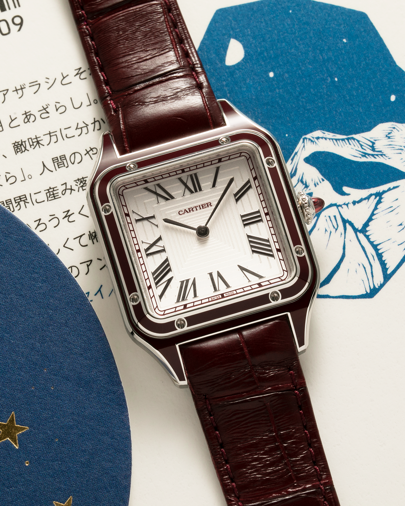 Brand: Cartier Year: 2022 Model: Santos-Dumont Large, Limited Edition of 150 pieces Reference Number: WGSA0053 Material: Platinum 950 Case, Burgundy Lacquered Bezel Movement: Cartier Cal. 430 MC, Manual-Winding Case Diameter: 43.5mm x 31.4mm Strap: Cartier Burgundy Alligator Leather Strap with Signed Platinum 950 Tang Buckle