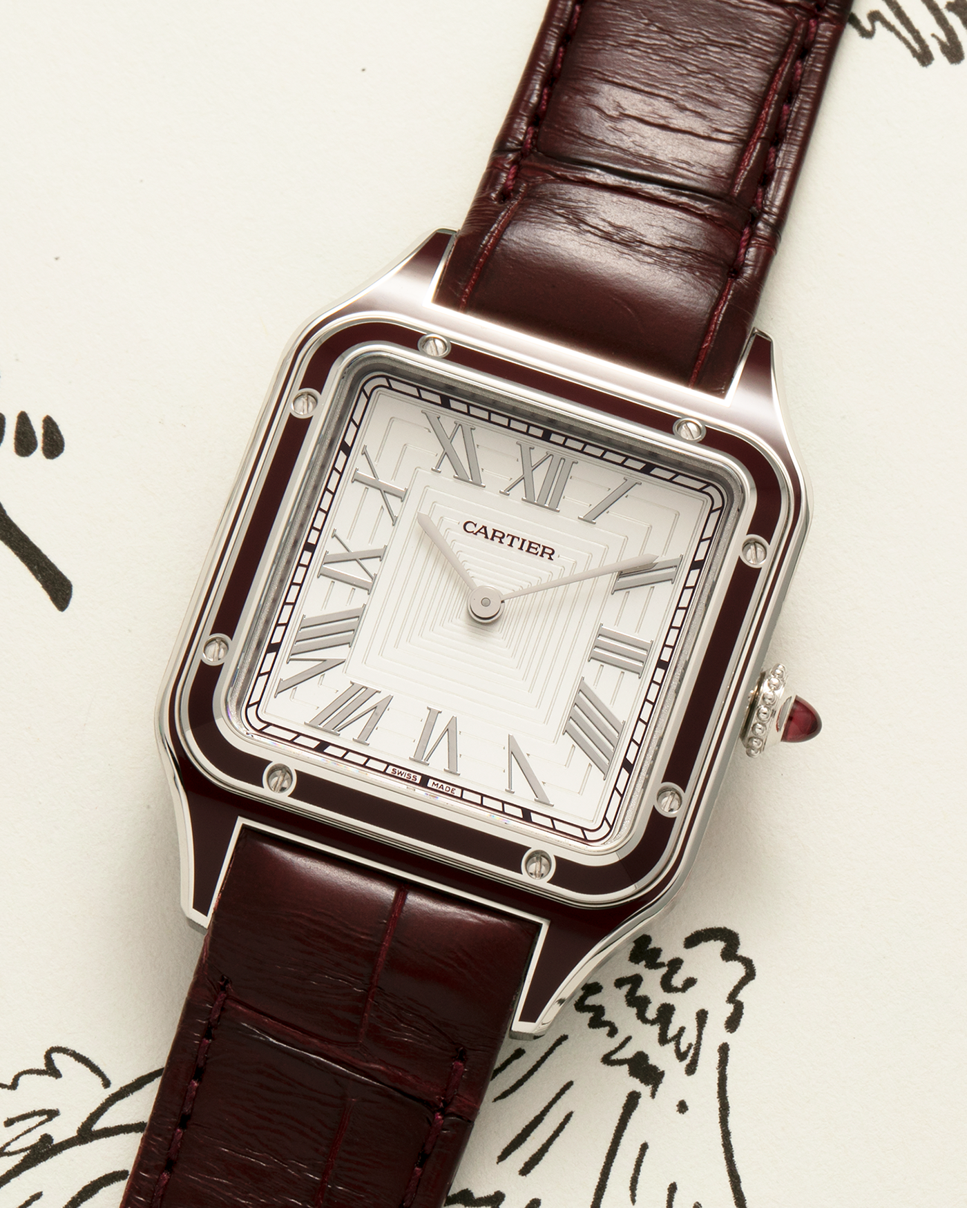 Brand: Cartier Year: 2022 Model: Santos-Dumont Large, Limited Edition of 150 pieces Reference Number: WGSA0053 Material: Platinum 950 Case, Burgundy Lacquered Bezel Movement: Cartier Cal. 430 MC, Manual-Winding Case Diameter: 43.5mm x 31.4mm Strap: Cartier Burgundy Alligator Leather Strap with Signed Platinum 950 Tang Buckle