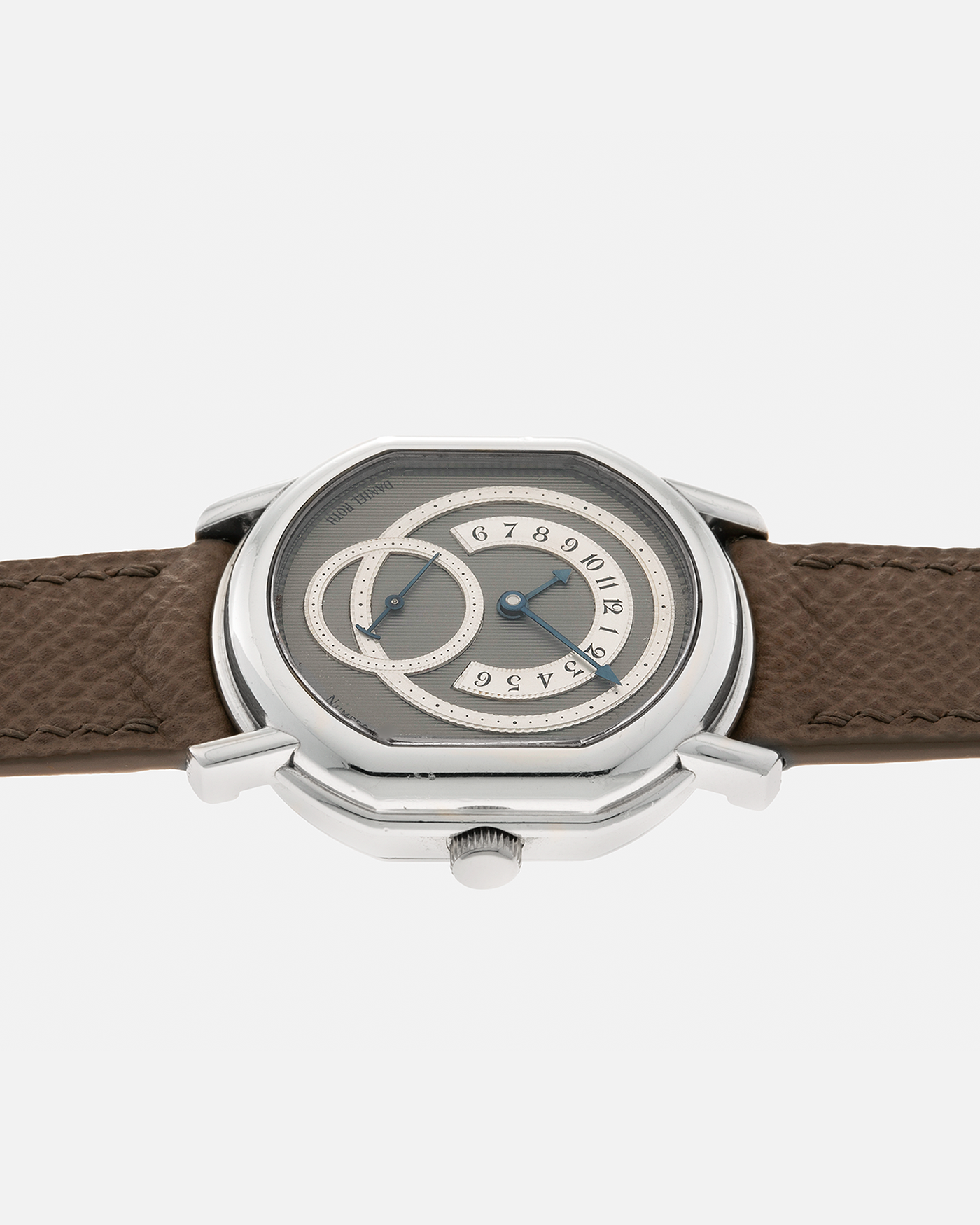 Brand: Daniel Roth Year: 1990’s Model: 2127 Retrograde Material: Platinum 950 Movement: Lemania Cal. 27LN Retrograde, Manual-Winding Case Dimensions: 35mm x 38mm Lug Width: 20mm Strap: Nostime Taupe Grained Calf Leather Strap with Signed Platinum 950 Tang Buckle