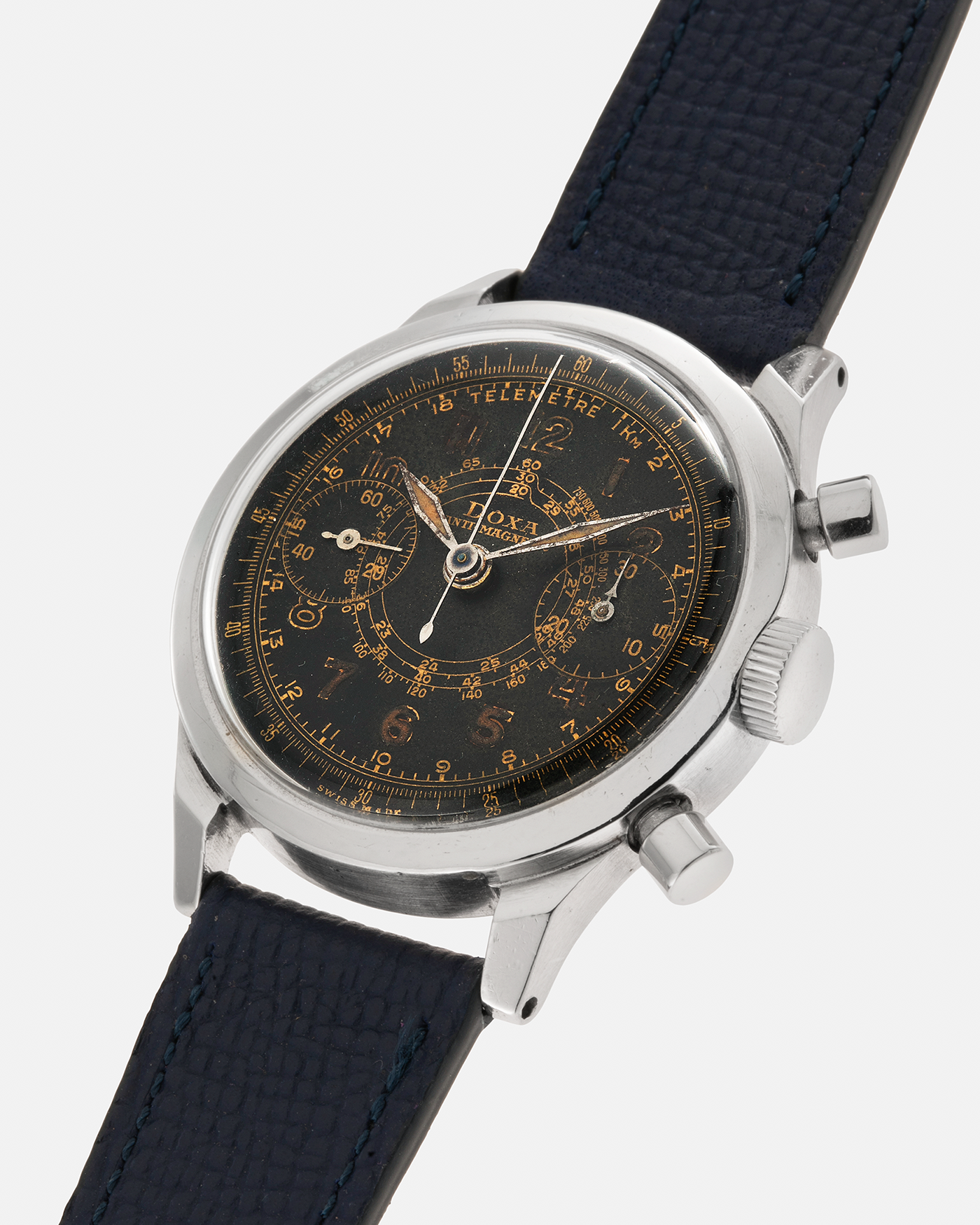 Brand: Doxa
Year: 1940s
Model: Anti-Magnetic Chronograph
Material: Stainless Steel
Movement: Valjoux Cal. 22, Manual-Winding
Case Diameter: 38mm
Lug Width: 19mm
Strap: Nostime Dark Navy Grained Calf Leather Strap