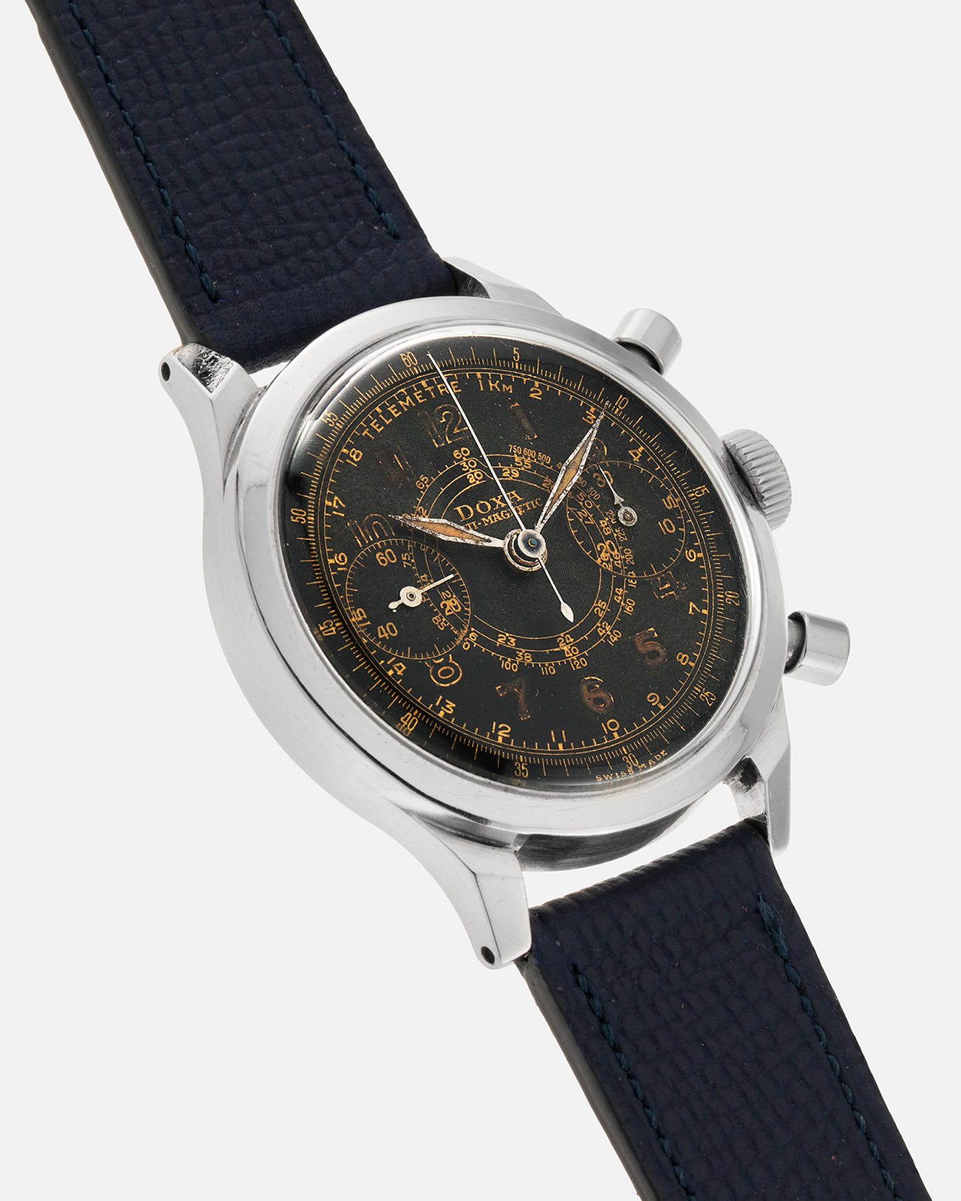 Brand: Doxa
Year: 1940s
Model: Anti-Magnetic Chronograph
Material: Stainless Steel
Movement: Valjoux Cal. 22, Manual-Winding
Case Diameter: 38mm
Lug Width: 19mm
Strap: Nostime Dark Navy Grained Calf Leather Strap