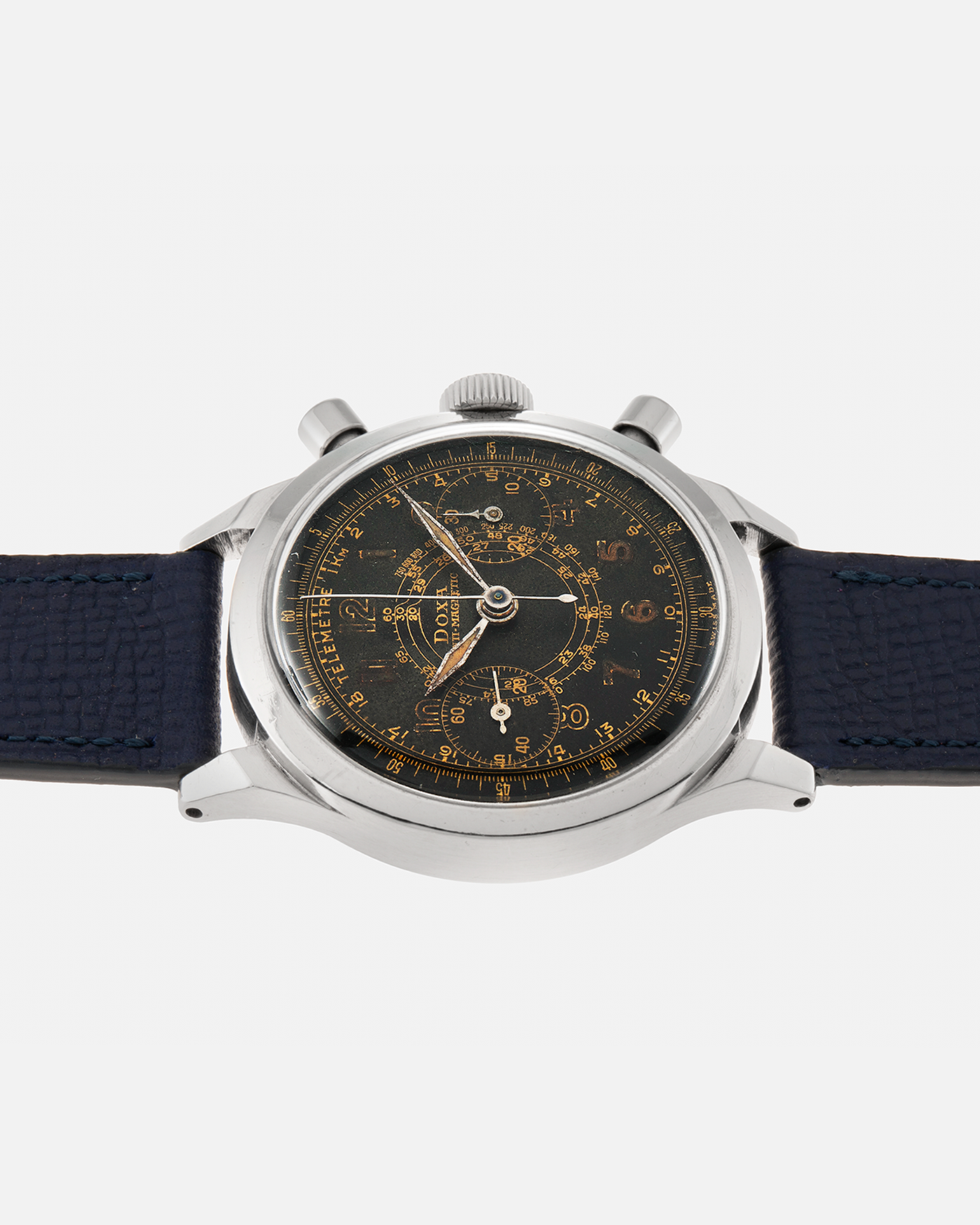 Brand: Doxa
Year: 1940s
Model: Anti-Magnetic Chronograph
Material: Stainless Steel
Movement: Valjoux Cal. 22, Manual-Winding
Case Diameter: 38mm
Lug Width: 19mm
Strap: Nostime Dark Navy Grained Calf Leather Strap