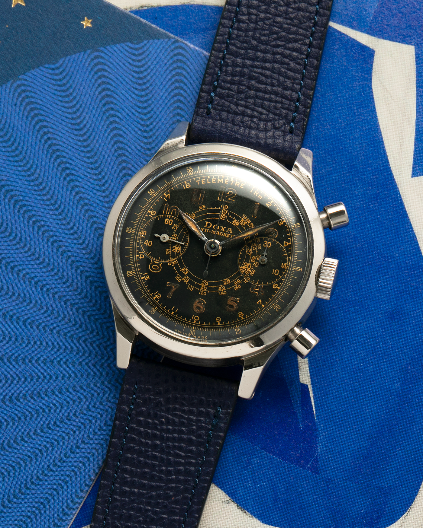 Brand: Doxa
Year: 1940s
Model: Anti-Magnetic Chronograph
Material: Stainless Steel
Movement: Valjoux Cal. 22, Manual-Winding
Case Diameter: 38mm
Lug Width: 19mm
Strap: Nostime Dark Navy Grained Calf Leather Strap