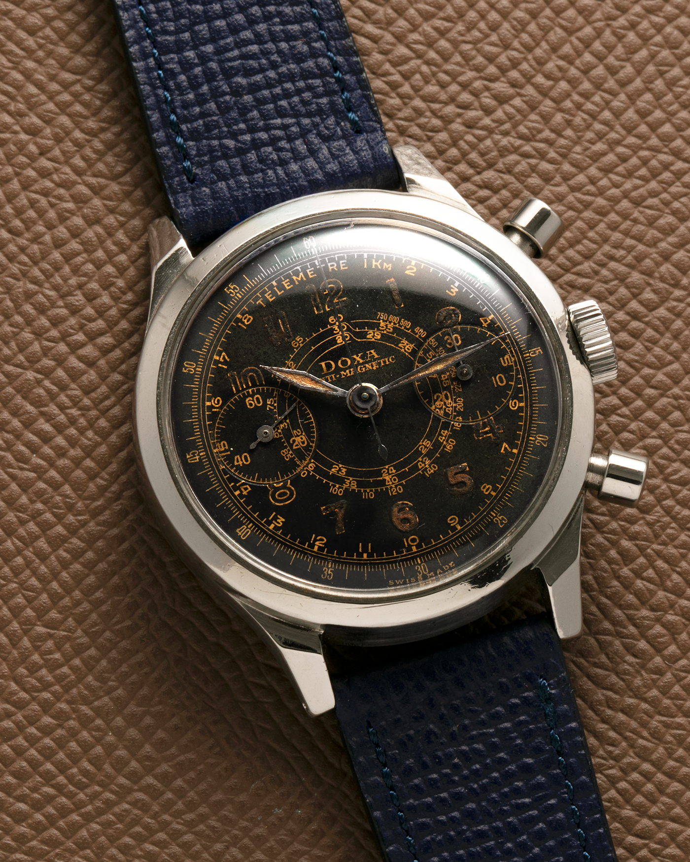 Brand: Doxa
Year: 1940s
Model: Anti-Magnetic Chronograph
Material: Stainless Steel
Movement: Valjoux Cal. 22, Manual-Winding
Case Diameter: 38mm
Lug Width: 19mm
Strap: Nostime Dark Navy Grained Calf Leather Strap