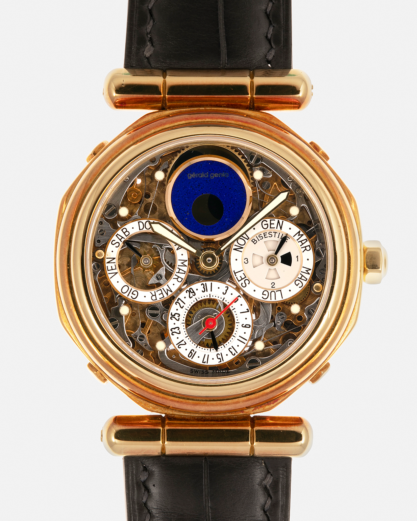 Brand: Gerald Genta
Year: 1990s
Serial Number: 47063
Reference Number: G.4009.4
Movement Number: 17
Material: 18-carat Yellow Gold Case, Lapis Lazuli Moon Phase
Movement: In-house Gilt Brass Caliber with Perpetual Calendar and Tourbillon, Self-Winding
Case Dimensions: 35mm x 11mm (Lug-to-Lug 43.8mm)
Lug Width: 19mm
Strap: Unnamed Custom Grey Alligator Leather Strap with Blue Underlining, additional Unnamed Brown Suede Calf Leather Strap with Signed 18-carat Yellow Gold Butterfly Clasp and Original Gold Stra