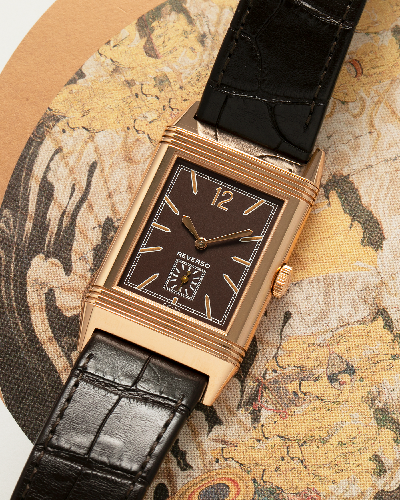 Brand: Jaeger LeCoultre
Year: 2020
Model: Q2782560, Grande Reverso Ultra Thin 1931 ‘Chocolate’
Reference Number: 277.2.22
Material: 18-carat Rose Gold
Movement: Jaeger LeCoultre Cal. 822/2, Manual-Winding
Case Diameter:  46.8mm (Including Lugs) x 27.4mm x 7.3mm
Lug Width: 20mm
Strap: Jaeger LeCoultre Dark Brown Alligator Leather Strap with Signed 18-carat Rose Gold Tang Buckle