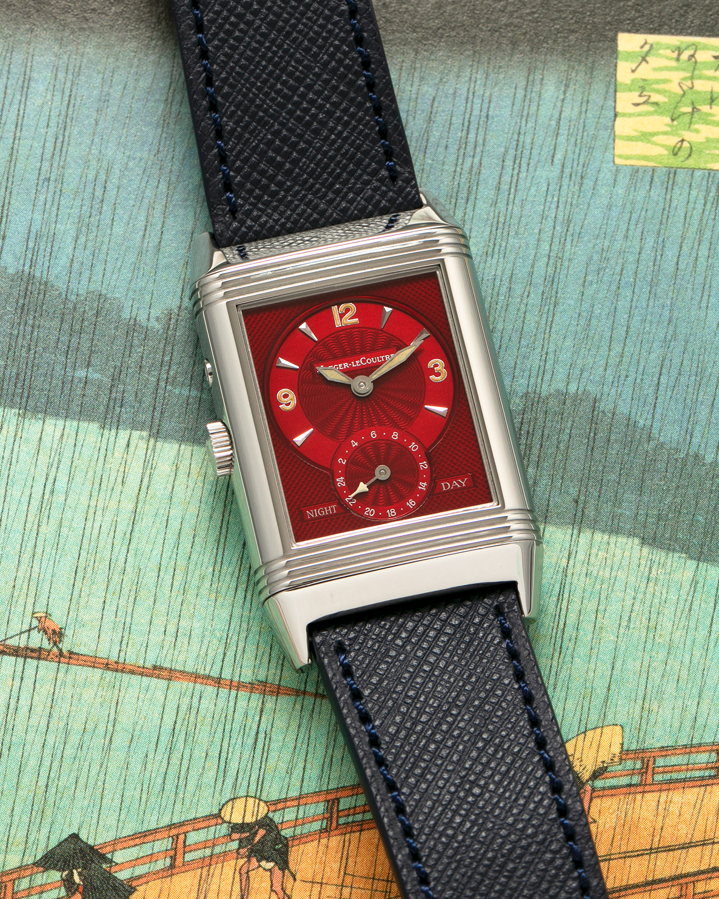 Brand: Jaeger-LeCoultre
Year: 2000’s
Model: Reverso Duoface Japan Edition Red, Ref. 270.8.54, Limited Edition of 300 Pieces
Material: Stainless Steel
Movement: Jaeger LeCoultre Cal. 854, Manual-Wind
Case Diameter: 26mm x 10mm x 42mm (Including Lugs)
Lug Width: 19mm
Strap: Molequin Dark Navy Blue Textured Calf with Signed Stainless Steel Deployant Clasp