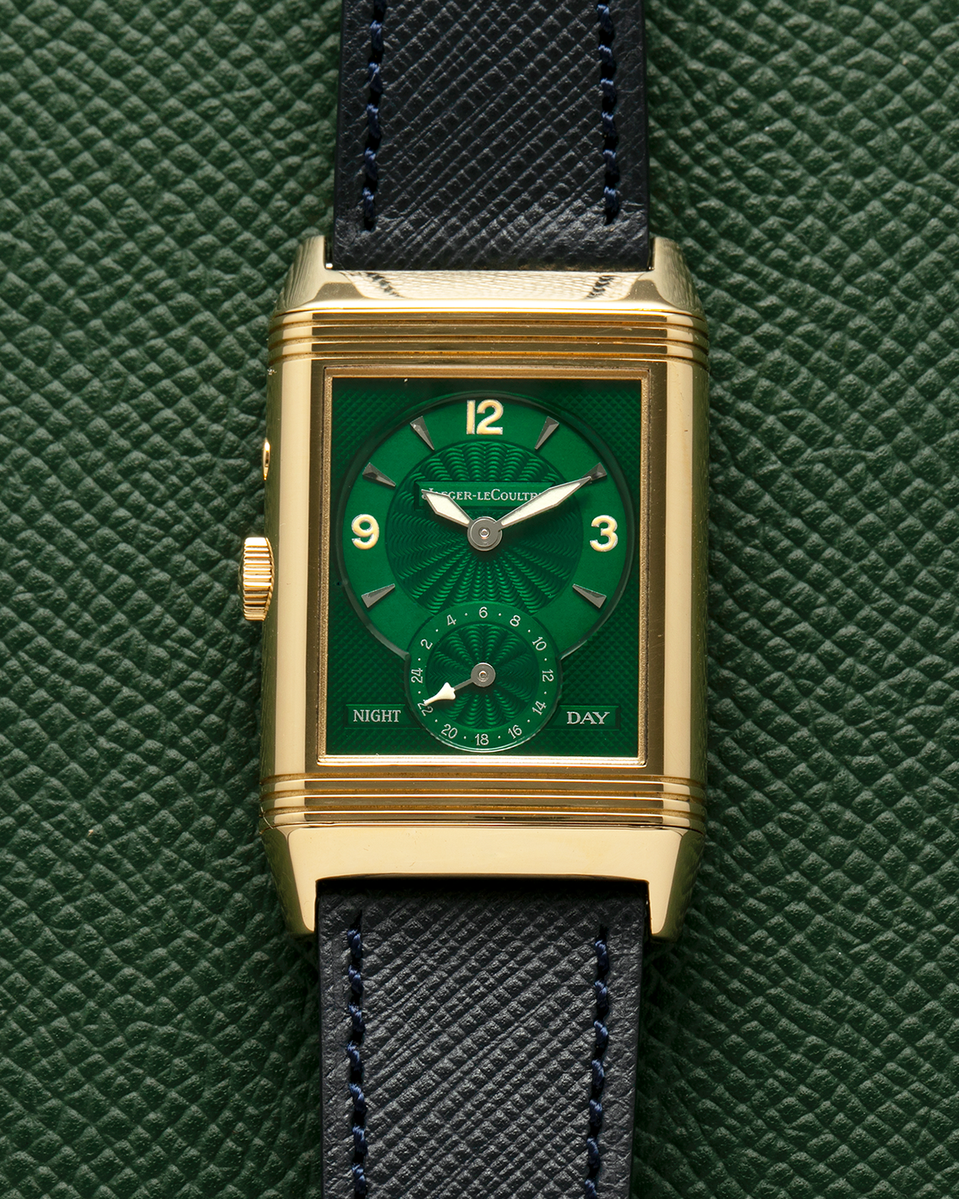 Brand: Jaeger LeCoultre
Year: 1990s
Model: Reverso Duoface Japan Edition Green, Limited Edition of 39 Pieces
Reference Number: 270.1.54
Material: 18-carat Yellow Gold
Movement: Jaeger LeCoultre Cal. 854, Manual-Wind
Case Diameter: 42mm (including lugs) x 26mm x 9.5mm
Lug Width: 19mm
Strap/Bracelet: Molequin Navy Blue Textured Calf Leather Strap with 18 carat JLC deployant clasp, with additional Two-Toned Jaeger LeCoultre signed bracelet