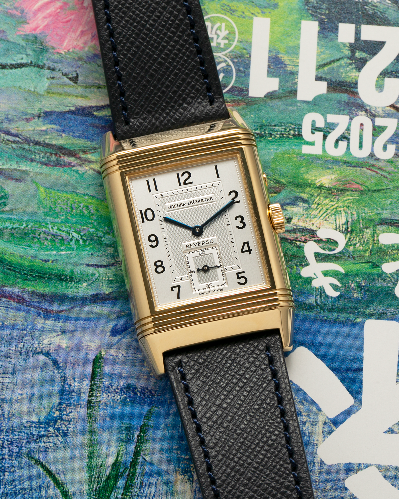 Brand: Jaeger LeCoultre
Year: 1990s
Model: Reverso Duoface Japan Edition Green, Limited Edition of 39 Pieces
Reference Number: 270.1.54
Material: 18-carat Yellow Gold
Movement: Jaeger LeCoultre Cal. 854, Manual-Wind
Case Diameter: 42mm (including lugs) x 26mm x 9.5mm
Lug Width: 19mm
Strap/Bracelet: Molequin Navy Blue Textured Calf Leather Strap with 18 carat JLC deployant clasp, with additional Two-Toned Jaeger LeCoultre signed bracelet