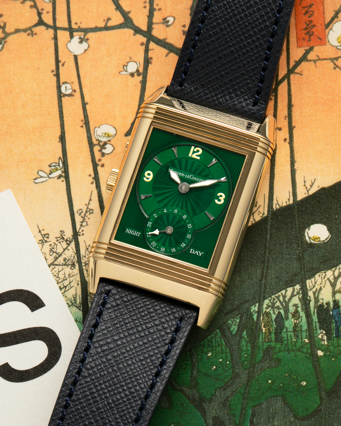 Brand: Jaeger LeCoultre
Year: 1990s
Model: Reverso Duoface Japan Edition Green, Limited Edition of 39 Pieces
Reference Number: 270.1.54
Material: 18-carat Yellow Gold
Movement: Jaeger LeCoultre Cal. 854, Manual-Wind
Case Diameter: 42mm (including lugs) x 26mm x 9.5mm
Lug Width: 19mm
Strap/Bracelet: Molequin Navy Blue Textured Calf Leather Strap with 18 carat JLC deployant clasp, with additional Two-Toned Jaeger LeCoultre signed bracelet