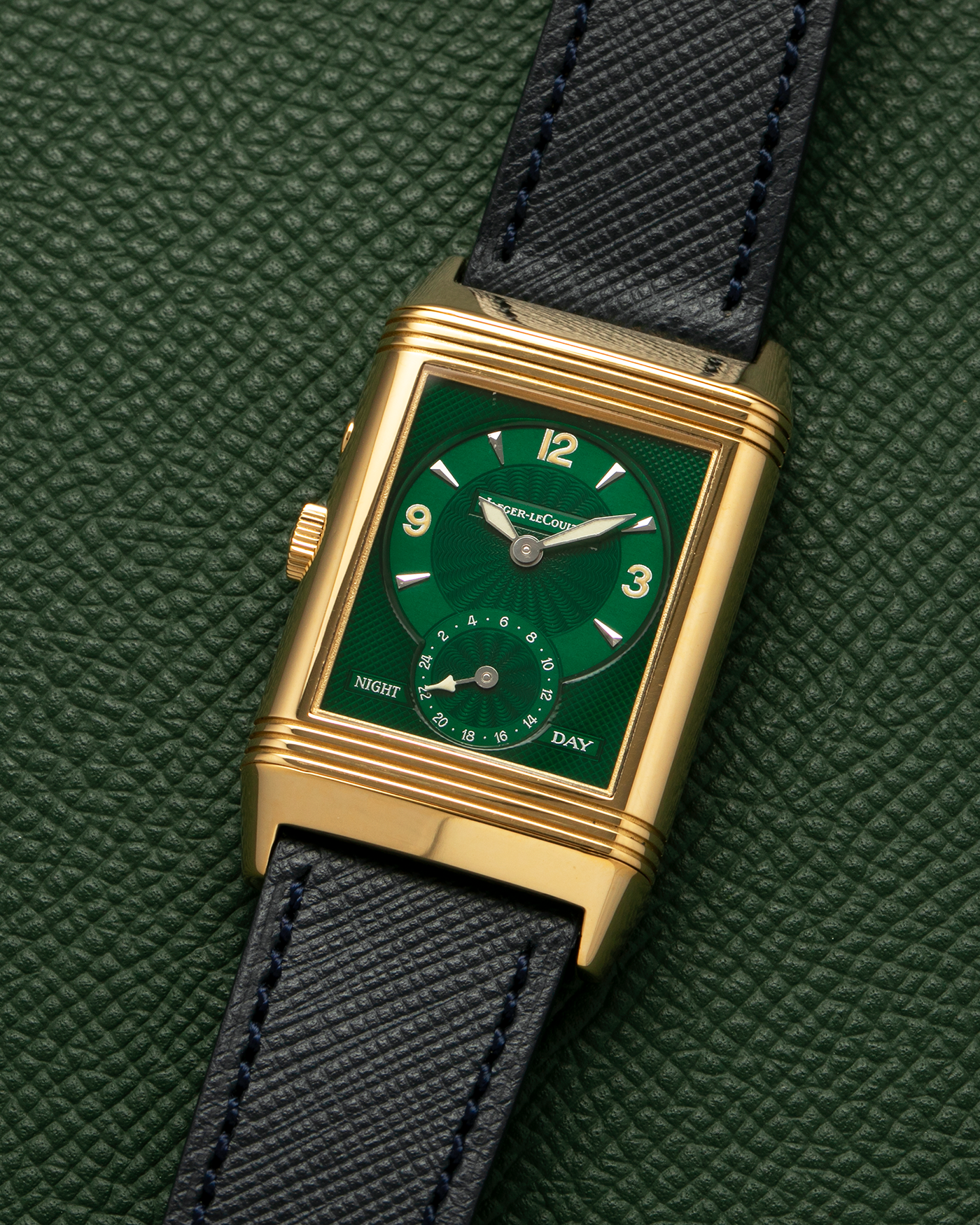 Brand: Jaeger LeCoultre
Year: 1990s
Model: Reverso Duoface Japan Edition Green, Limited Edition of 39 Pieces
Reference Number: 270.1.54
Material: 18-carat Yellow Gold
Movement: Jaeger LeCoultre Cal. 854, Manual-Wind
Case Diameter: 42mm (including lugs) x 26mm x 9.5mm
Lug Width: 19mm
Strap/Bracelet: Molequin Navy Blue Textured Calf Leather Strap with 18 carat JLC deployant clasp, with additional Two-Toned Jaeger LeCoultre signed bracelet