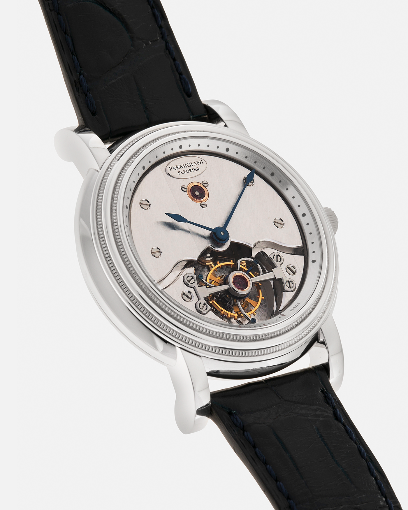 Brand: Parmigiani Fleurier
Year: 2001
Model: Toric Tourbillon
Reference: 2840
Material: Platinum 950
Movement: Parmigiani Fleurier Cal. PF280 (Based on Girard Perregaux Three Bridges 9900 ébauche, Manual-Winding
Case Dimensions: 40mm x 11mm (Lug-to-Lug 48mm)
Lug Width: 20mm
Strap: Camille Fornet Cousu Main Dark Navy Alligator Leather Strap with Signed Platinum 950 Deployant Clasp