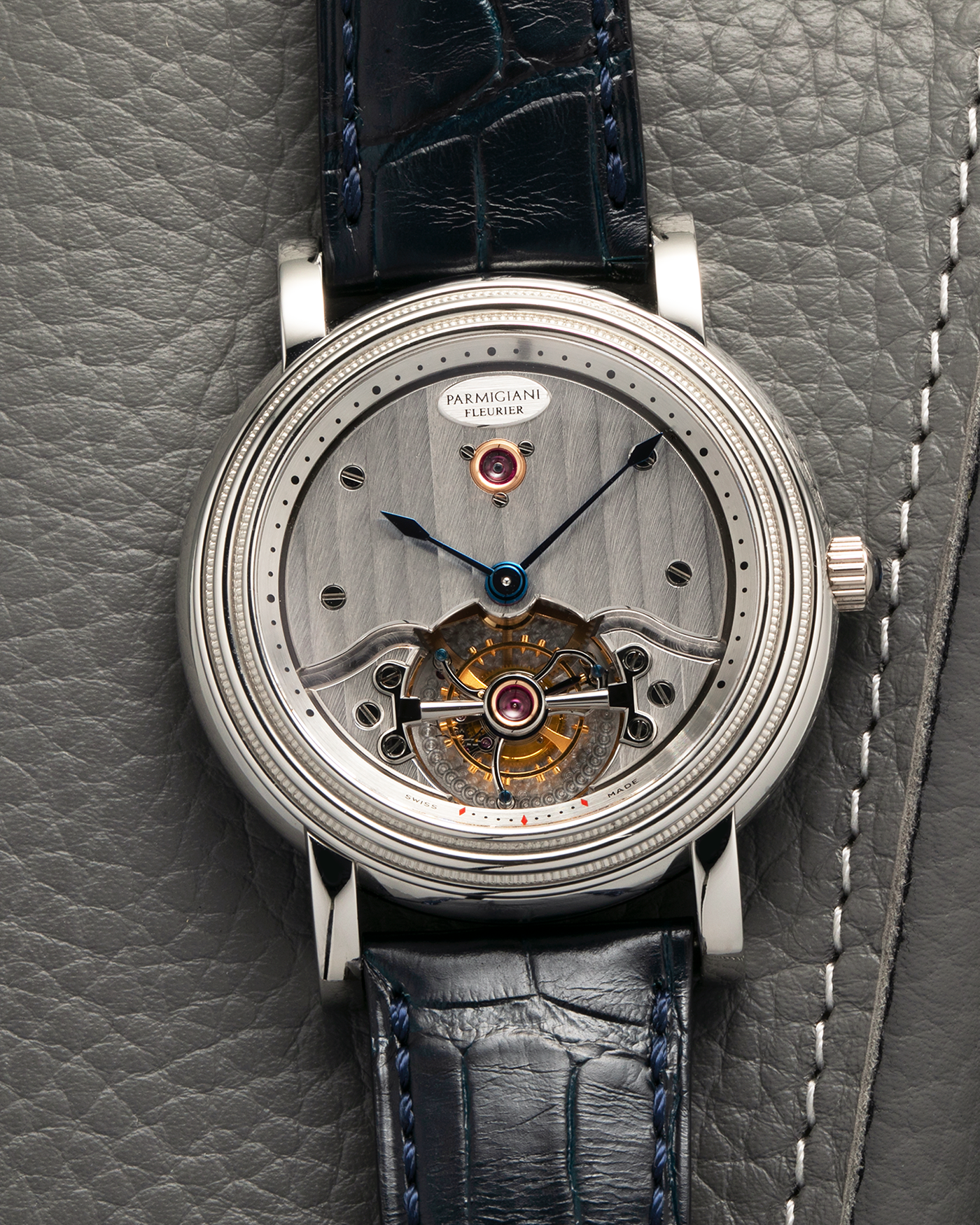 Brand: Parmigiani Fleurier
Year: 2001
Model: Toric Tourbillon
Reference: 2840
Material: Platinum 950
Movement: Parmigiani Fleurier Cal. PF280 (Based on Girard Perregaux Three Bridges 9900 ébauche, Manual-Winding
Case Dimensions: 40mm x 11mm (Lug-to-Lug 48mm)
Lug Width: 20mm
Strap: Camille Fornet Cousu Main Dark Navy Alligator Leather Strap with Signed Platinum 950 Deployant Clasp