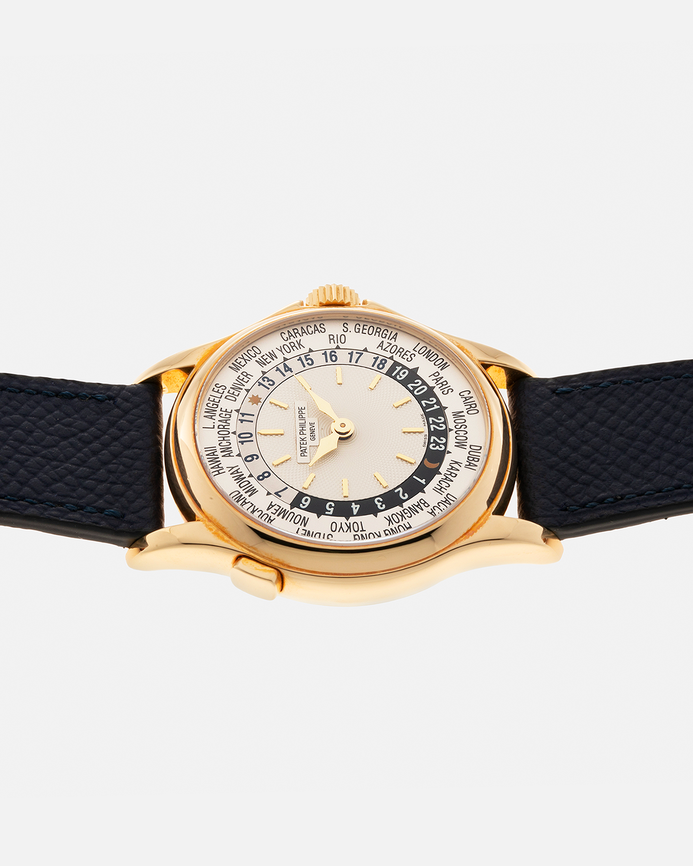 Brand: Patek Philippe Year: 2000s Model: World Time Reference Number: 5110J Material: 18-carat Yellow Gold Movement: Patek Philippe Cal. 240 HU Micro-Rotor, Self-Winding Case Diameter: 37mm Lug Width: 20mm Bracelet: Nostime Navy Blue Textured Calf Leather Strap with Signed 18-carat Yellow Gold Deployant Clasp, Patek Philippe Brown Alligator Leather Strap (Used)