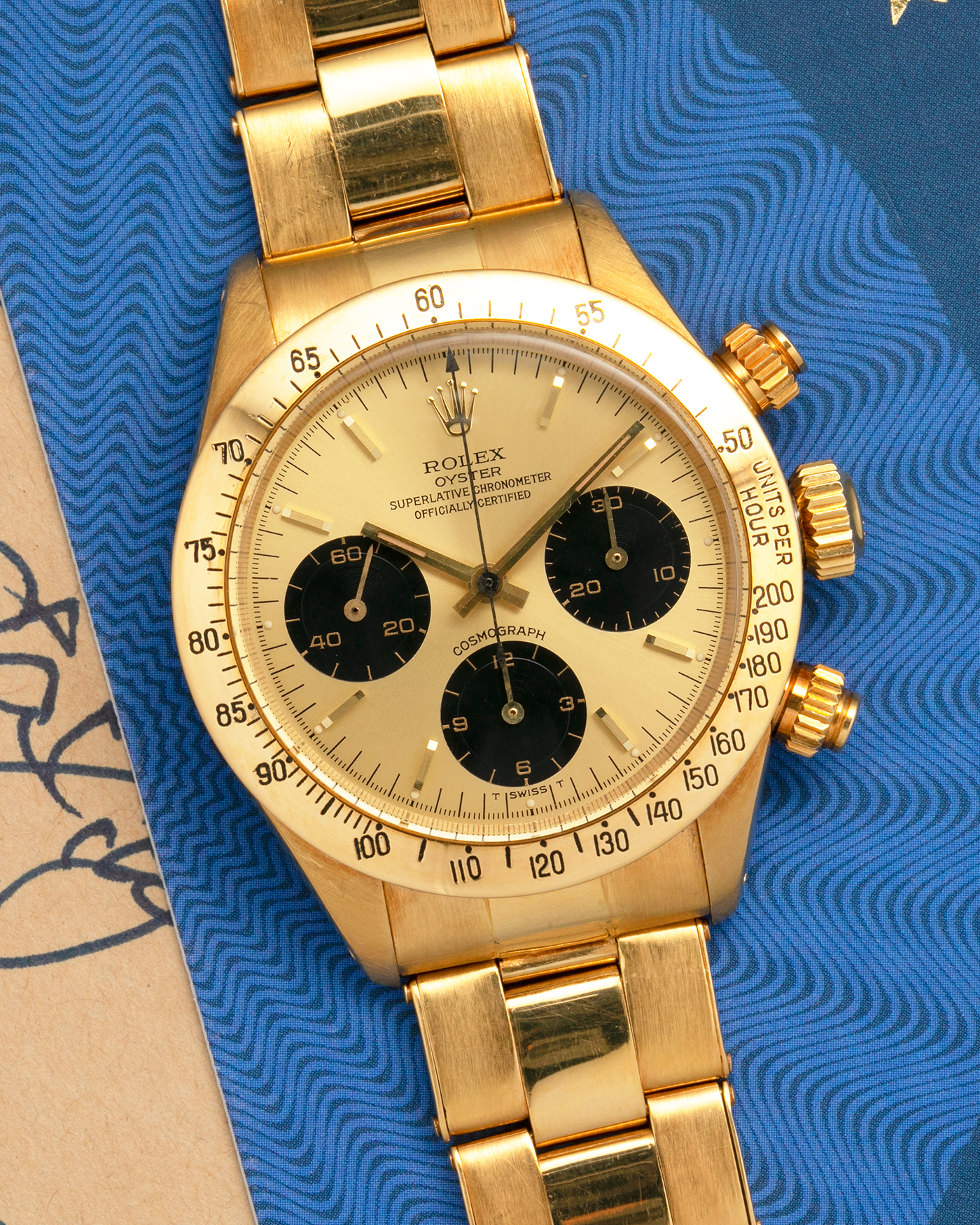 Brand: Rolex
Year: 1979
Model: Cosmograph Daytona
Serial Number: 595XXXX
Reference Number: 6265
Material: 18-carat Yellow Gold
Movement: Rolex Cal. 727 (Based on Valjoux Cal. 72), Manual-Winding
Case Diameter: 37.5mm x 13.5mm (Lug-to-Lug 45mm)
Lug Width: 19mm
Bracelet: Rolex Oyster Swiss Rivet Bracelet in 18-carat Yellow Gold with ‘57’ Curved End Links and Signed Clasp