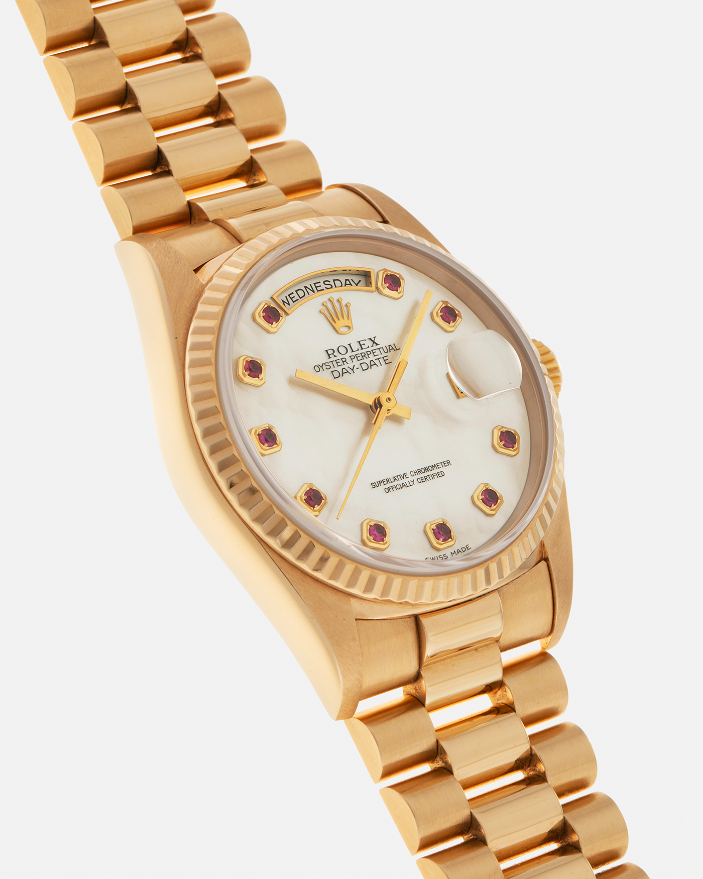 Brand: Rolex
Year: 1989
Model: Day-Date ‘Mother-of-Pearl Rubies’
Reference Number: 18238
Serial Number: L980XXX
Material: 18-carat Yellow Gold
Movement: Rolex Cal. 3155, Self-Winding
Case Dimensions: 36mm x 12mm (Lug-to-Lug 43.7mm)
Lug Width: 20mm
Bracelet: Rolex 18-carat Yellow Gold ‘8385’ Presidential Bracelet with 55B Curved End Links and Signed ‘O5’ Folding Clasp