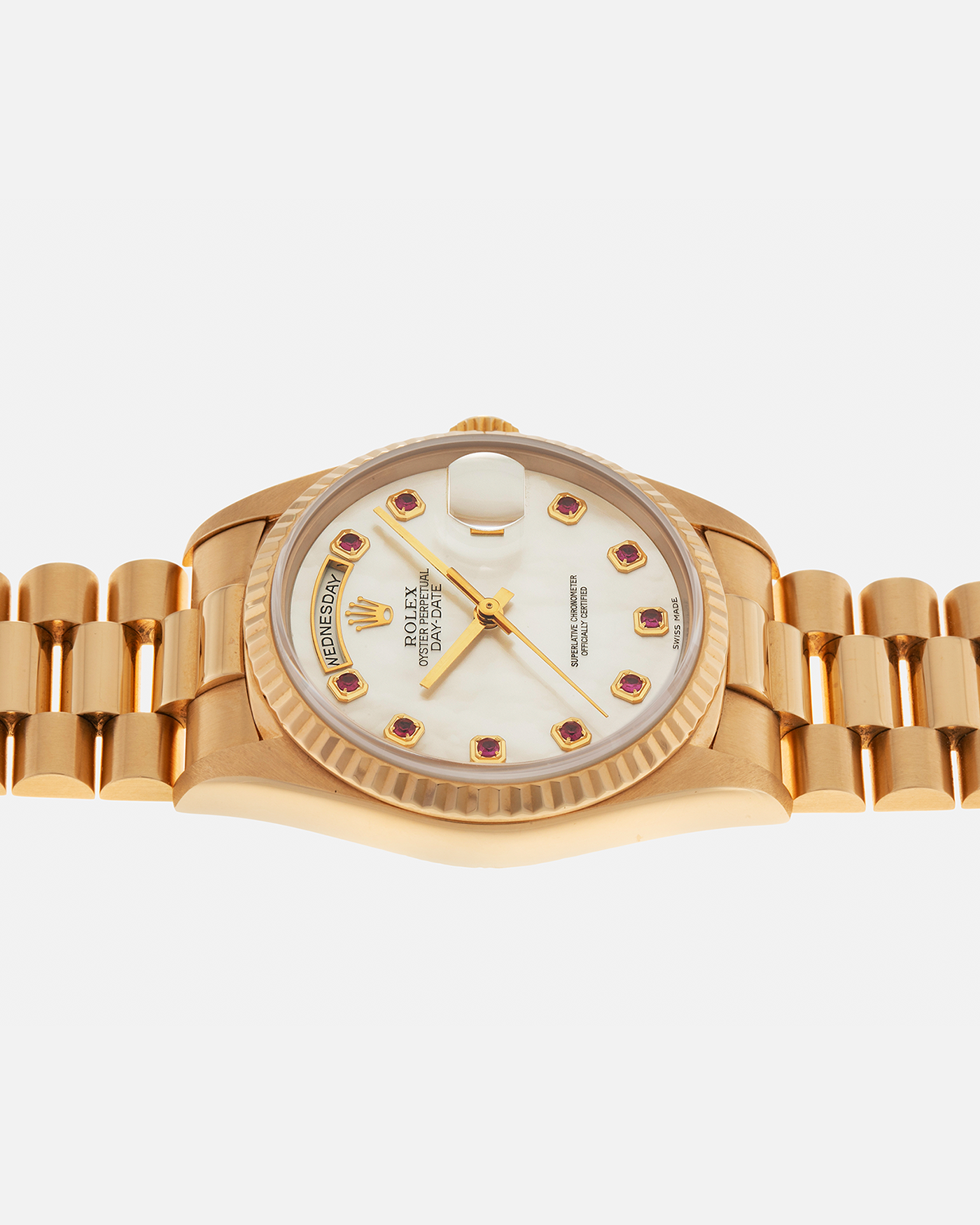 Brand: Rolex
Year: 1989
Model: Day-Date ‘Mother-of-Pearl Rubies’
Reference Number: 18238
Serial Number: L980XXX
Material: 18-carat Yellow Gold
Movement: Rolex Cal. 3155, Self-Winding
Case Dimensions: 36mm x 12mm (Lug-to-Lug 43.7mm)
Lug Width: 20mm
Bracelet: Rolex 18-carat Yellow Gold ‘8385’ Presidential Bracelet with 55B Curved End Links and Signed ‘O5’ Folding Clasp