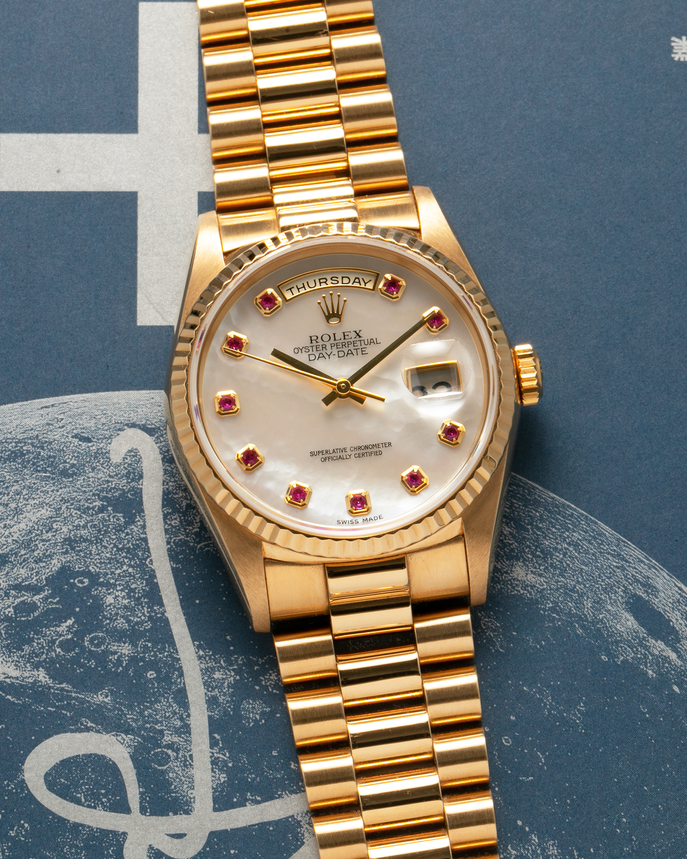 Brand: Rolex
Year: 1989
Model: Day-Date ‘Mother-of-Pearl Rubies’
Reference Number: 18238
Serial Number: L980XXX
Material: 18-carat Yellow Gold
Movement: Rolex Cal. 3155, Self-Winding
Case Dimensions: 36mm x 12mm (Lug-to-Lug 43.7mm)
Lug Width: 20mm
Bracelet: Rolex 18-carat Yellow Gold ‘8385’ Presidential Bracelet with 55B Curved End Links and Signed ‘O5’ Folding Clasp