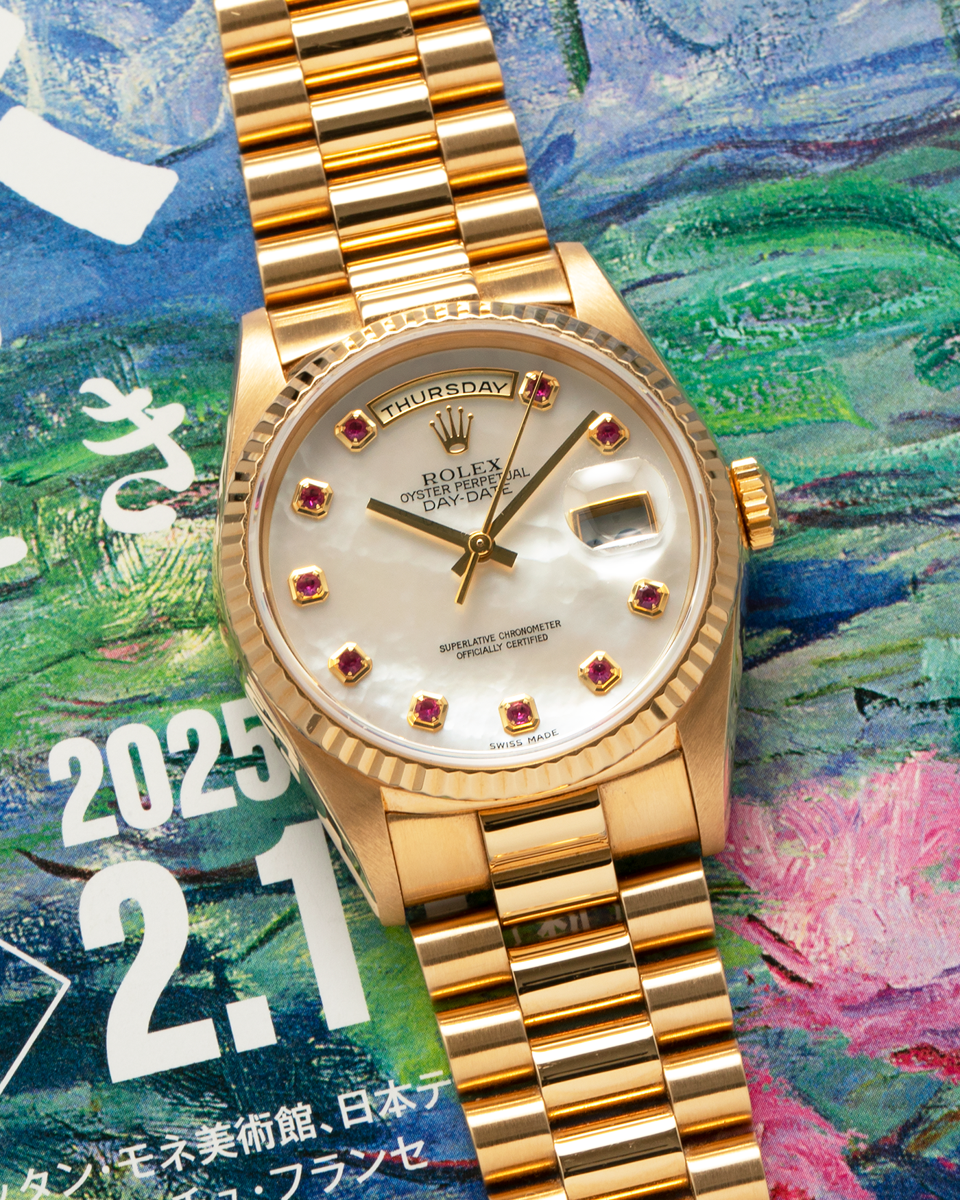 Brand: Rolex
Year: 1989
Model: Day-Date ‘Mother-of-Pearl Rubies’
Reference Number: 18238
Serial Number: L980XXX
Material: 18-carat Yellow Gold
Movement: Rolex Cal. 3155, Self-Winding
Case Dimensions: 36mm x 12mm (Lug-to-Lug 43.7mm)
Lug Width: 20mm
Bracelet: Rolex 18-carat Yellow Gold ‘8385’ Presidential Bracelet with 55B Curved End Links and Signed ‘O5’ Folding Clasp