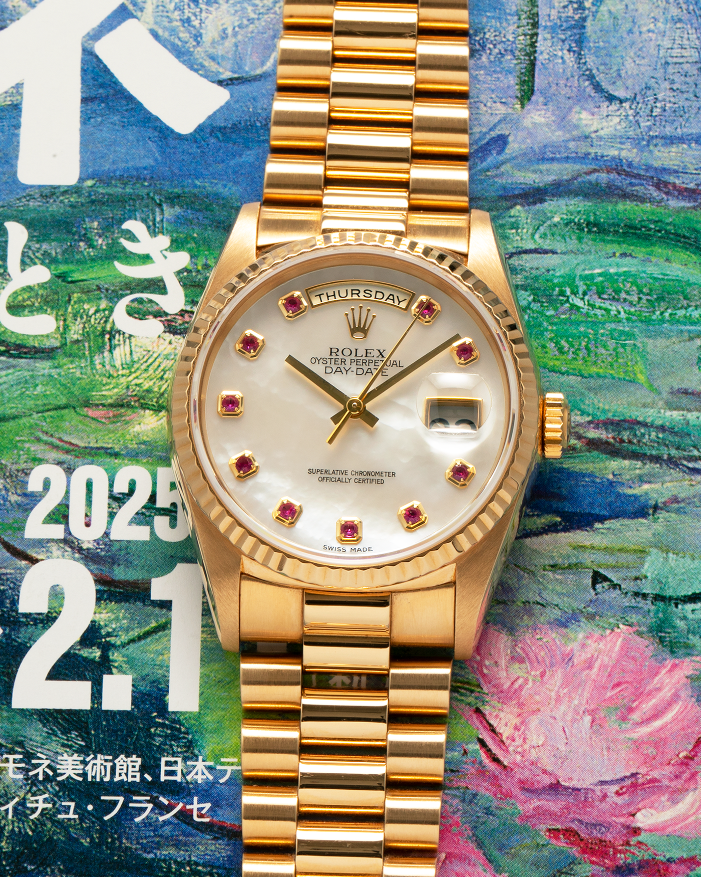 Brand: Rolex
Year: 1989
Model: Day-Date ‘Mother-of-Pearl Rubies’
Reference Number: 18238
Serial Number: L980XXX
Material: 18-carat Yellow Gold
Movement: Rolex Cal. 3155, Self-Winding
Case Dimensions: 36mm x 12mm (Lug-to-Lug 43.7mm)
Lug Width: 20mm
Bracelet: Rolex 18-carat Yellow Gold ‘8385’ Presidential Bracelet with 55B Curved End Links and Signed ‘O5’ Folding Clasp