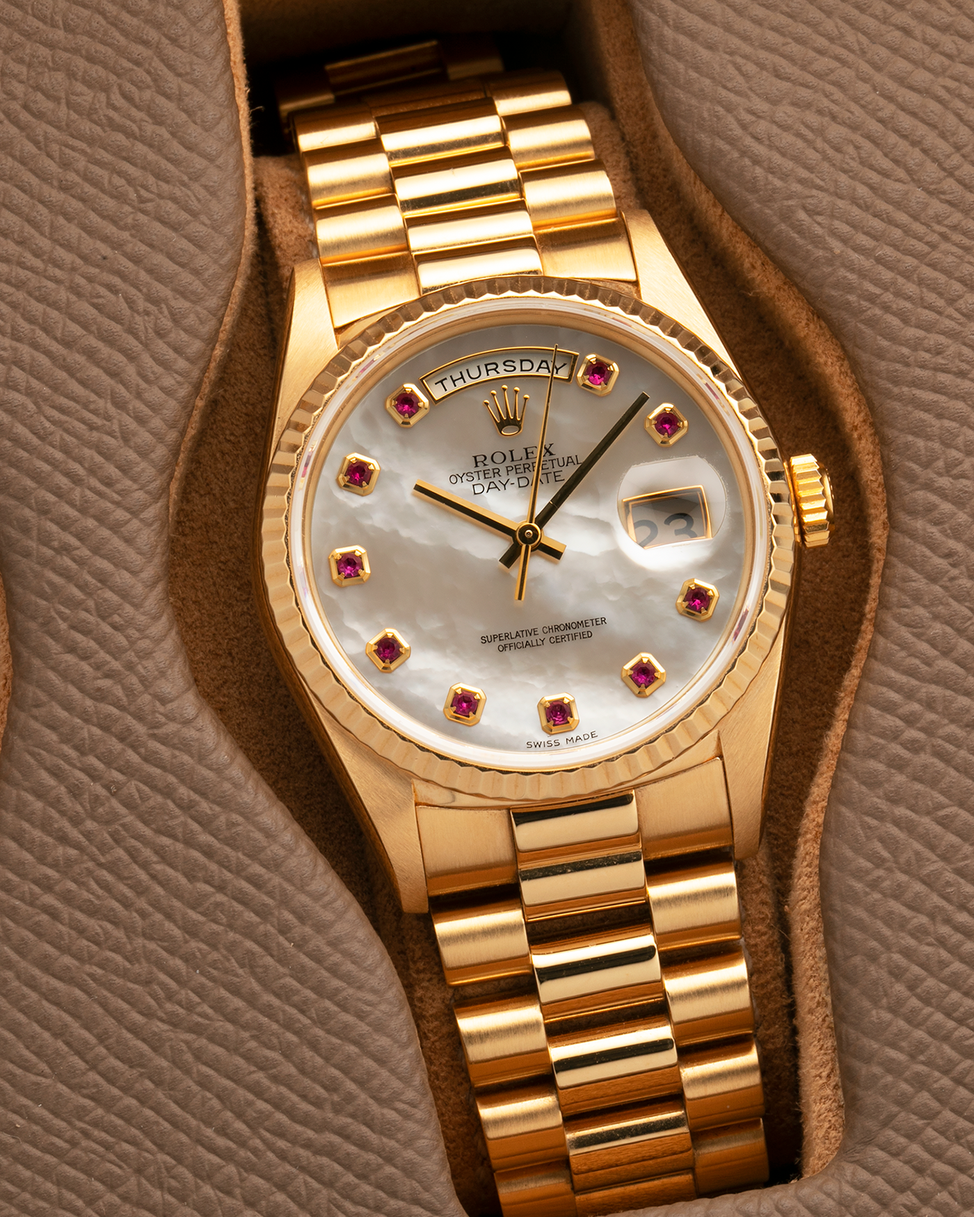 Brand: Rolex
Year: 1989
Model: Day-Date ‘Mother-of-Pearl Rubies’
Reference Number: 18238
Serial Number: L980XXX
Material: 18-carat Yellow Gold
Movement: Rolex Cal. 3155, Self-Winding
Case Dimensions: 36mm x 12mm (Lug-to-Lug 43.7mm)
Lug Width: 20mm
Bracelet: Rolex 18-carat Yellow Gold ‘8385’ Presidential Bracelet with 55B Curved End Links and Signed ‘O5’ Folding Clasp