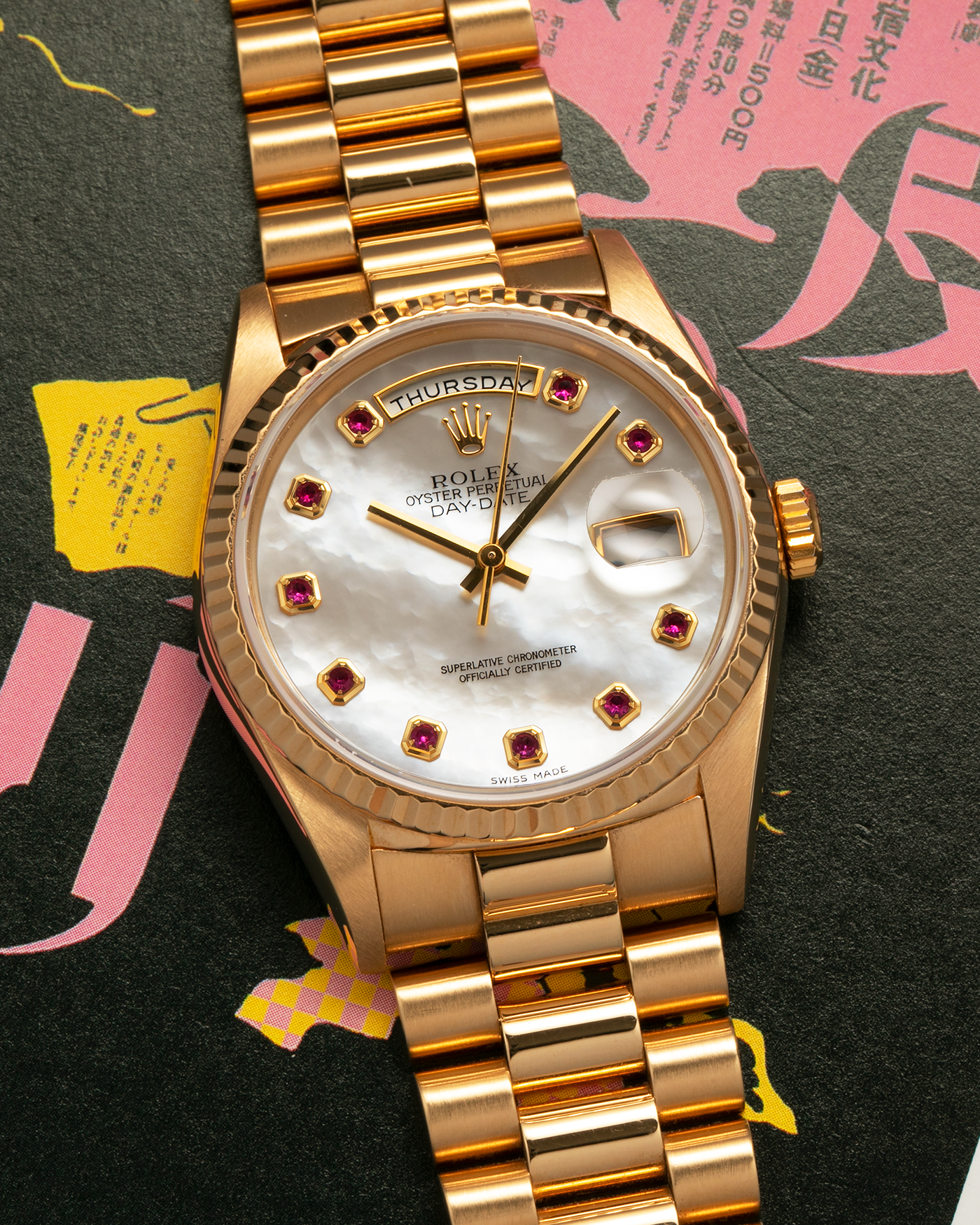 Brand: Rolex
Year: 1989
Model: Day-Date ‘Mother-of-Pearl Rubies’
Reference Number: 18238
Serial Number: L980XXX
Material: 18-carat Yellow Gold
Movement: Rolex Cal. 3155, Self-Winding
Case Dimensions: 36mm x 12mm (Lug-to-Lug 43.7mm)
Lug Width: 20mm
Bracelet: Rolex 18-carat Yellow Gold ‘8385’ Presidential Bracelet with 55B Curved End Links and Signed ‘O5’ Folding Clasp