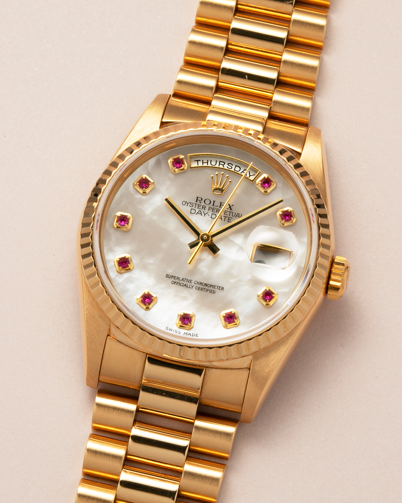 Brand: Rolex
Year: 1989
Model: Day-Date ‘Mother-of-Pearl Rubies’
Reference Number: 18238
Serial Number: L980XXX
Material: 18-carat Yellow Gold
Movement: Rolex Cal. 3155, Self-Winding
Case Dimensions: 36mm x 12mm (Lug-to-Lug 43.7mm)
Lug Width: 20mm
Bracelet: Rolex 18-carat Yellow Gold ‘8385’ Presidential Bracelet with 55B Curved End Links and Signed ‘O5’ Folding Clasp