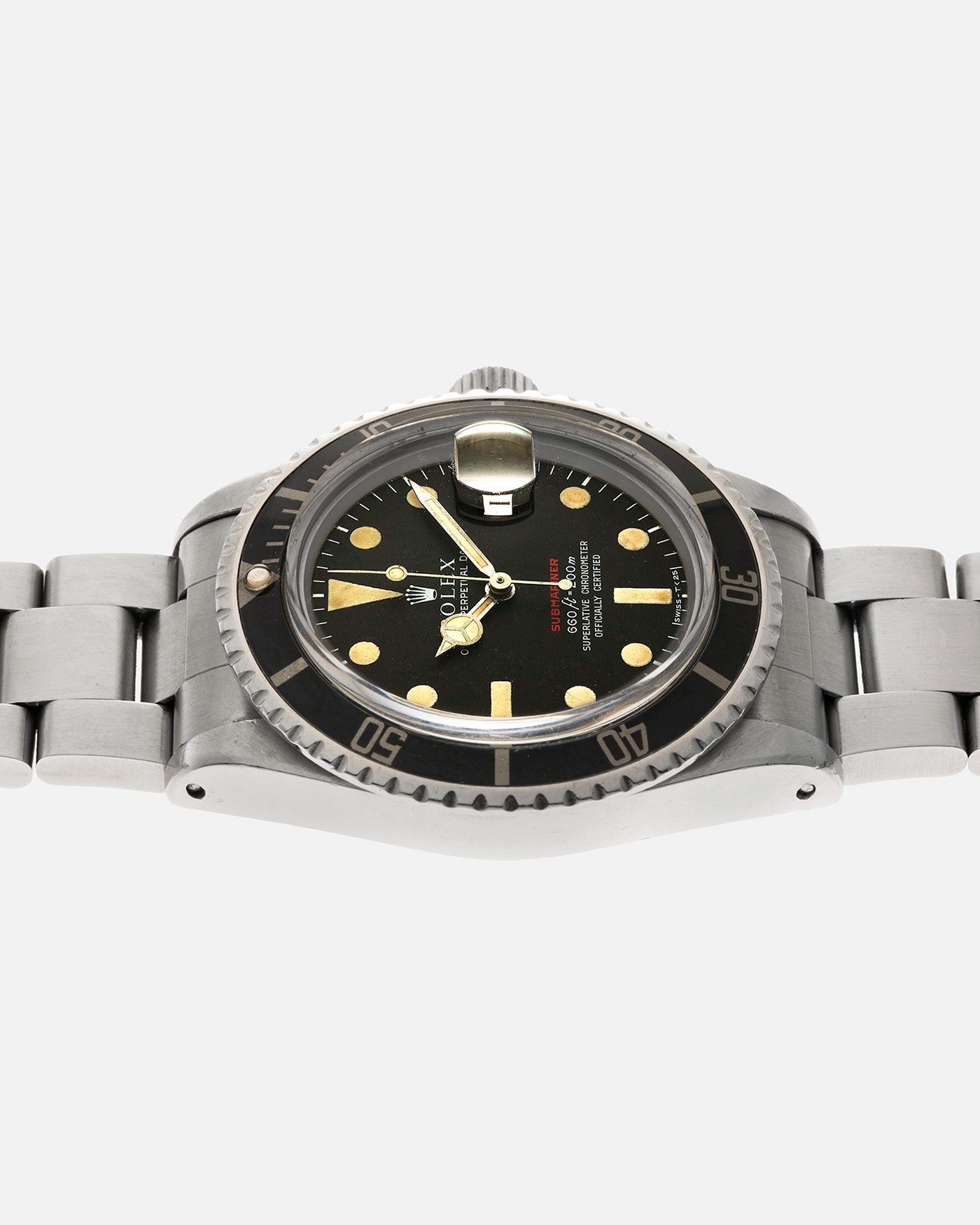 Brand: Rolex Year: 1970 Model: ‘Red’ Submariner Reference Number: 1680 Serial Number: 2437XXX Material: Stainless Steel Movement: Rolex Cal. 1570, Self-Winding Case Diameter: 40mm Lug Width: 20mm Bracelet: Rolex Stainless Steel ‘93150’ Oyster Bracelet with ‘580’ Endlinks