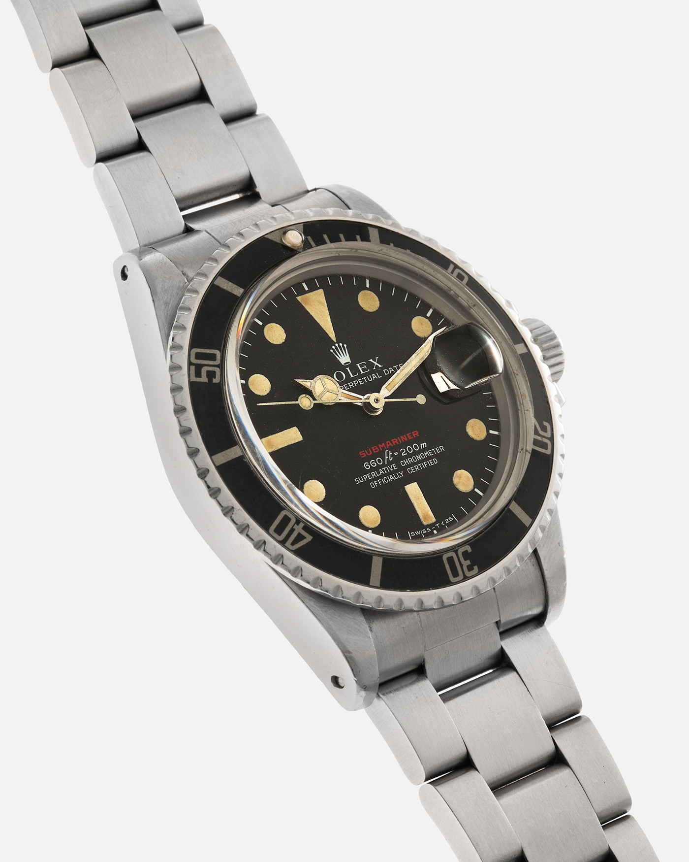 Brand: Rolex Year: 1970 Model: ‘Red’ Submariner Reference Number: 1680 Serial Number: 2437XXX Material: Stainless Steel Movement: Rolex Cal. 1570, Self-Winding Case Diameter: 40mm Lug Width: 20mm Bracelet: Rolex Stainless Steel ‘93150’ Oyster Bracelet with ‘580’ Endlinks