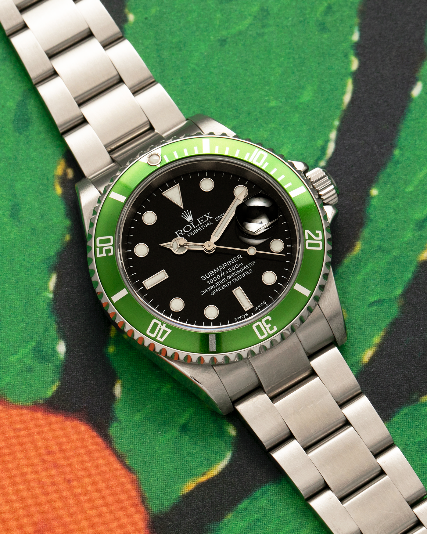 Brand: Rolex Year: 2004 Model: Submariner ‘Kermit’ Reference Number: 16610LV ‘Flat 4’ Serial Number: F Serial Material: Stainless Steel Movement: Rolex Cal. 3135, Self-Winding Case Diameter: 40mm Lug Width: 20mm Bracelet: Rolex Stainless Steel ‘93250’ Oyster Bracelet with signed ‘CL3’ Clasp