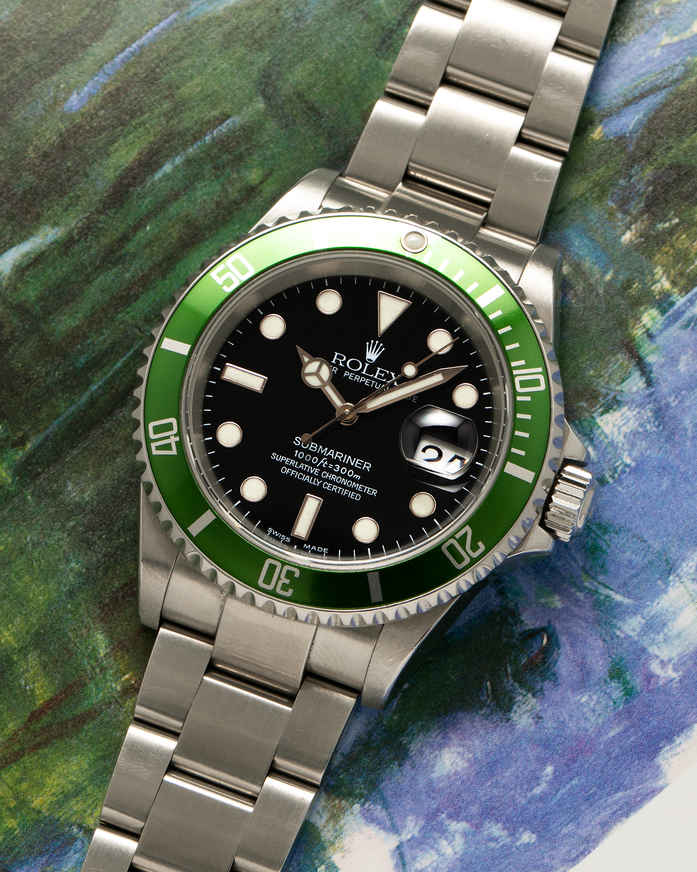 Brand: Rolex Year: 2004 Model: Submariner ‘Kermit’ Reference Number: 16610LV ‘Flat 4’ Serial Number: F Serial Material: Stainless Steel Movement: Rolex Cal. 3135, Self-Winding Case Diameter: 40mm Lug Width: 20mm Bracelet: Rolex Stainless Steel ‘93250’ Oyster Bracelet with signed ‘CL3’ Clasp