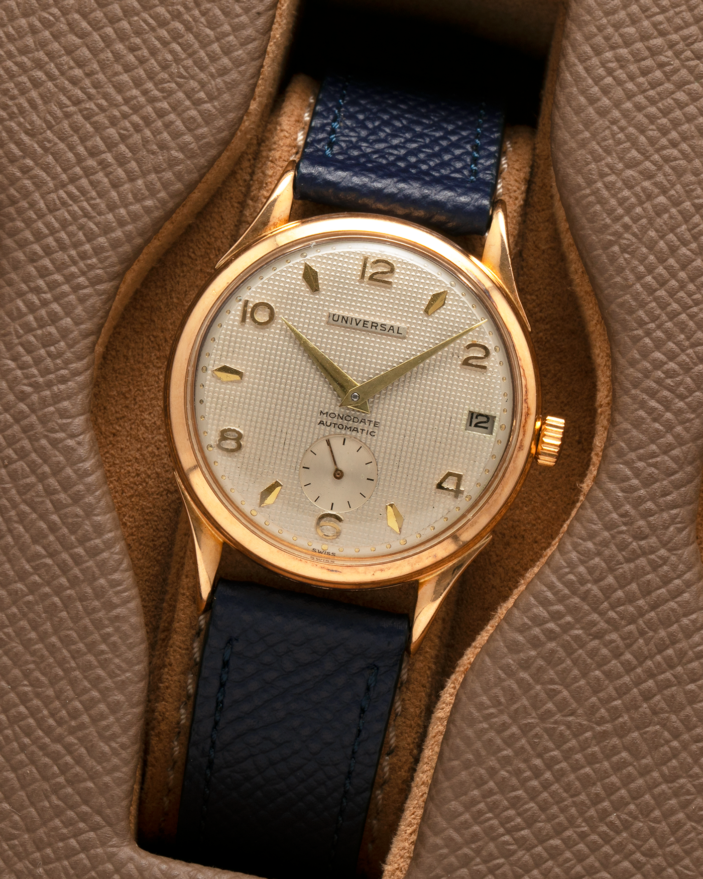 Brand: Universal Genève 
Year: 1950s
Material: 18-carat Yellow Gold
Movement: Universal Genève Cal. 138C, Bumper Self-Winding
Case Dimensions: 35mm x 10.5mm (Lug-to-Lug 43mm)
Lug Width: 18mm
Strap: Nostime Dark Navy Textured Calf Leather Strap 