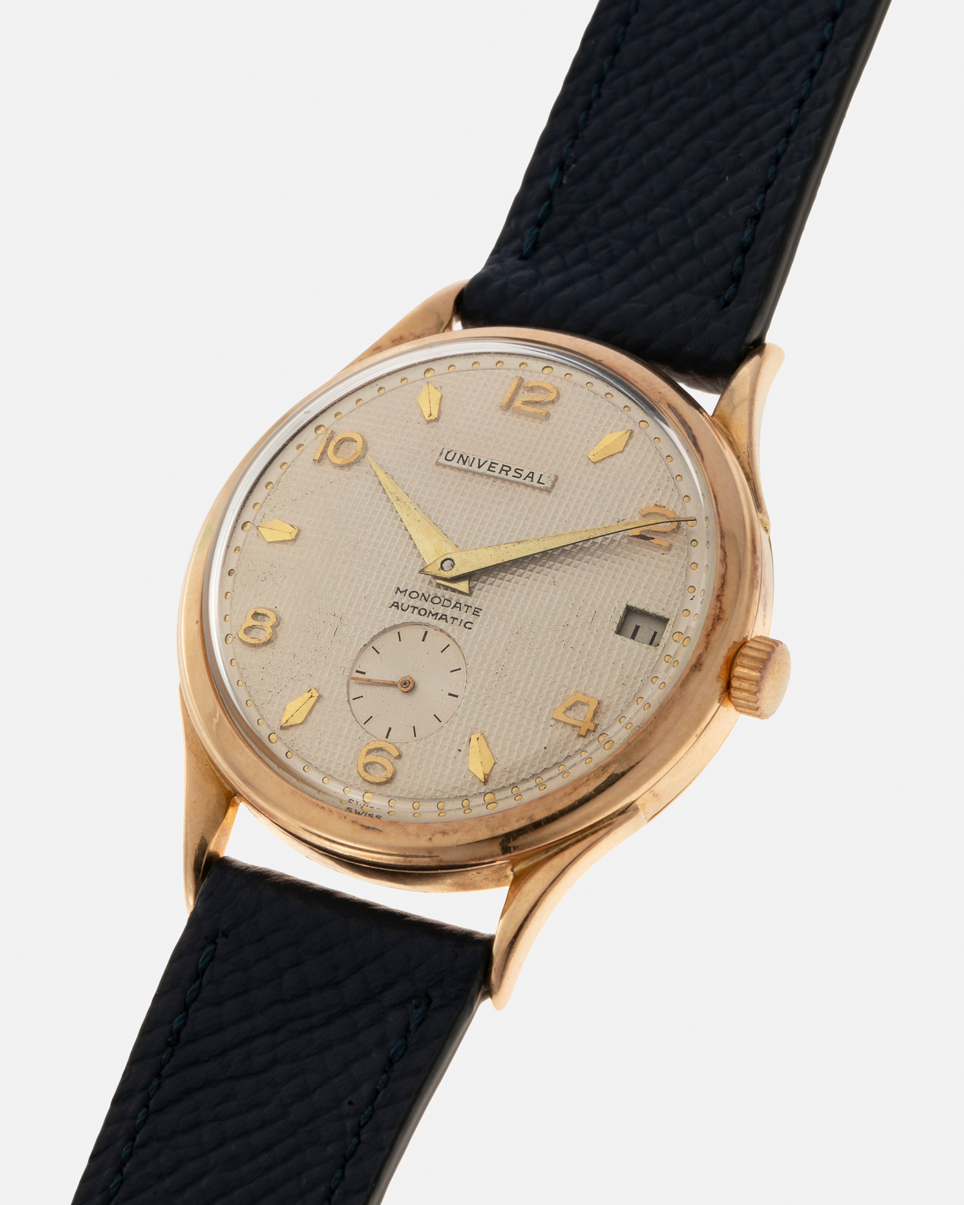 Brand: Universal Genève 
Year: 1950s
Material: 18-carat Yellow Gold
Movement: Universal Genève Cal. 138C, Bumper Self-Winding
Case Dimensions: 35mm x 10.5mm (Lug-to-Lug 43mm)
Lug Width: 18mm
Strap: Nostime Dark Navy Textured Calf Leather Strap 