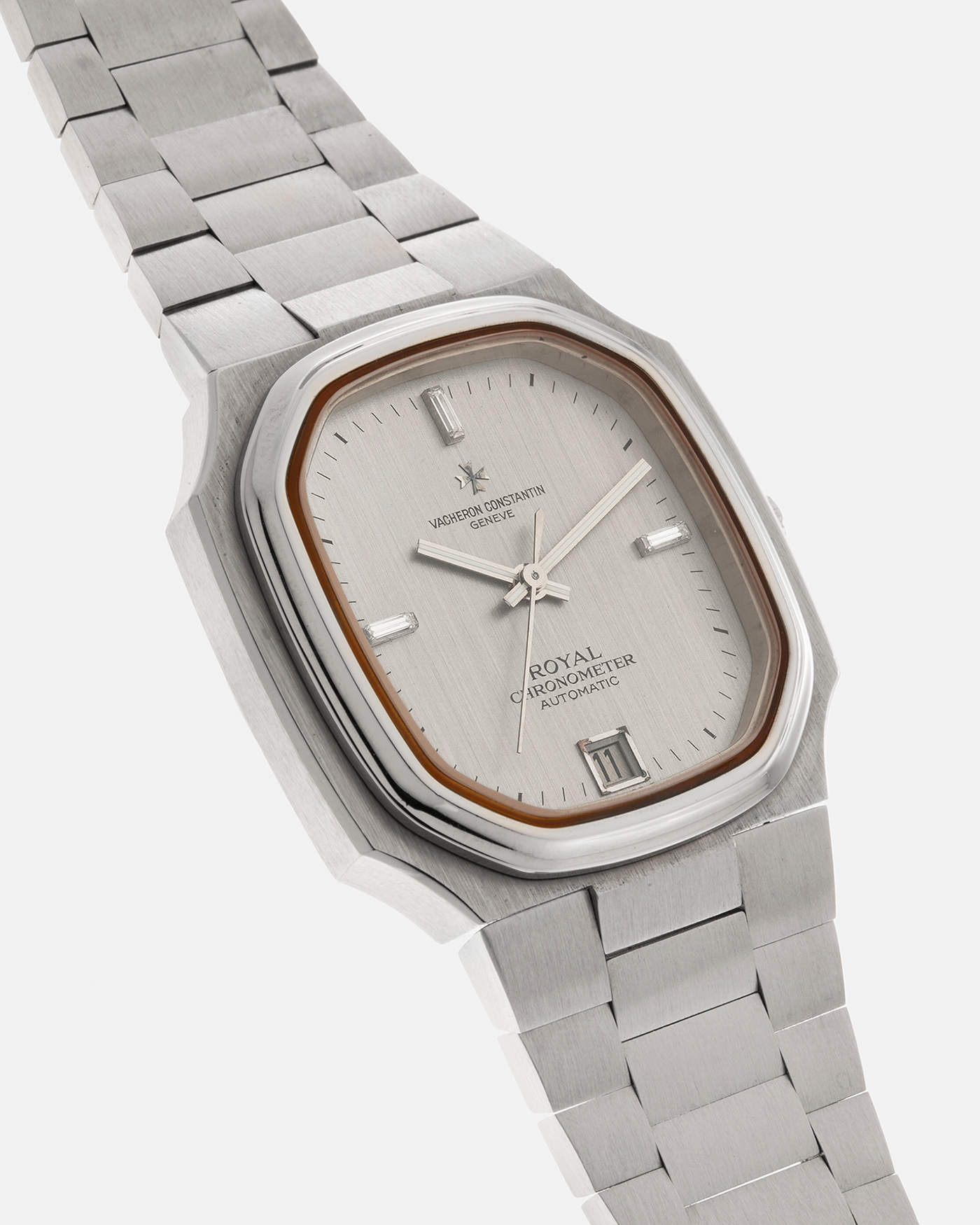 Brand: Vacheron Constantin Year: Mid-1970s Model: Chronometer Royal ‘Diamonds’ Reference Number: 2215 Material: Stainless Steel Case, White Gold Baton Hands, Factory Applied Baguette Diamonds at 3, 9, and 12 o’clock Movement: Vacheron Constantin Cal. 1096, Self-Winding Case Dimensions: 37mm x 10.3mm Bracelet: Vacheron Constantin Stainless Steel Integrated Three-Link Bracelet with Maltese Signed Clasp