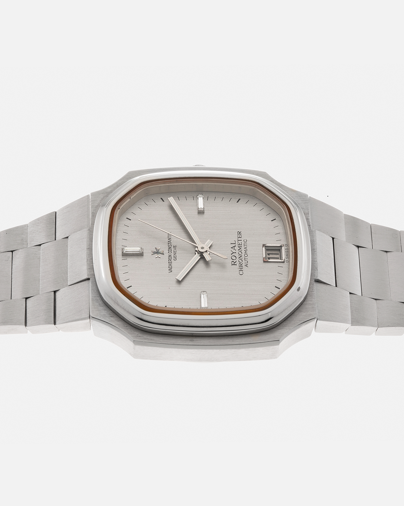 Brand: Vacheron Constantin Year: Mid-1970s Model: Chronometer Royal ‘Diamonds’ Reference Number: 2215 Material: Stainless Steel Case, White Gold Baton Hands, Factory Applied Baguette Diamonds at 3, 9, and 12 o’clock Movement: Vacheron Constantin Cal. 1096, Self-Winding Case Dimensions: 37mm x 10.3mm Bracelet: Vacheron Constantin Stainless Steel Integrated Three-Link Bracelet with Maltese Signed Clasp