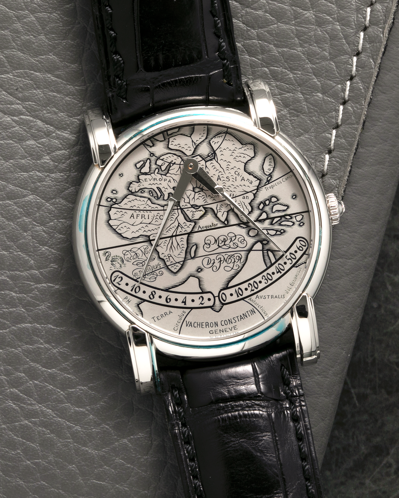 Brand: Vacheron Constantin
Year: 1990s
Model: Mercator
Reference Number: 43050
Material: Platinum 950 Case and Engraved Gold Dial filled with Black Enamel
Movement: Vacheron Constantin Cal. 1120 M (Heavily Modified Jaeger LeCoultre Cal. 920), Self-Winding
Case Diameter: 36mm x 9mm (Lug-to-Lug 41mm)
Lug Width: 19mm
Strap: Vacheron Constantin Black Alligator Leather Strap with Signed Platinum 950 Deployant Clasp