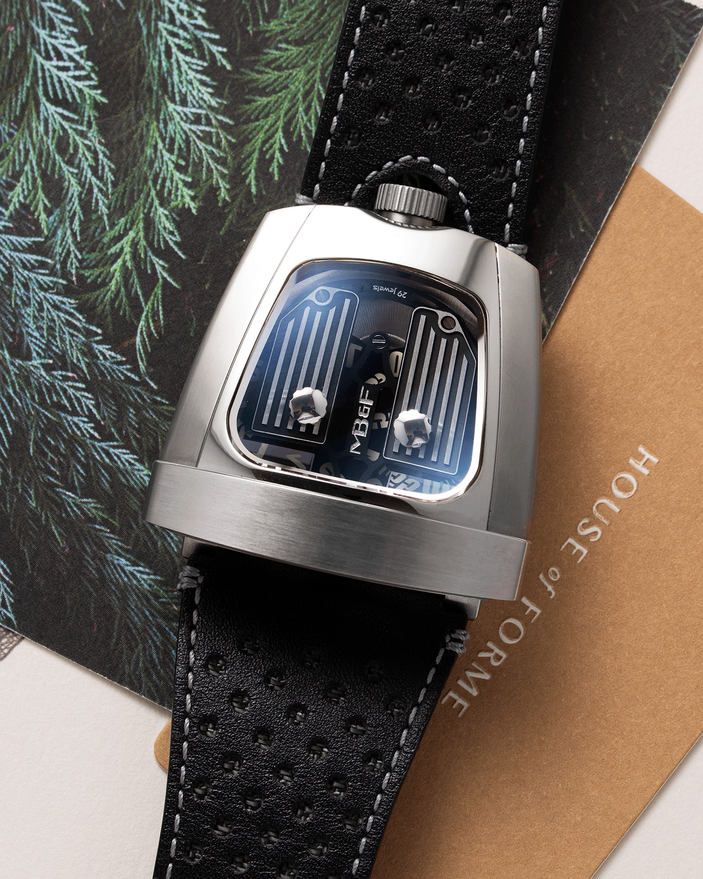 Brand: MB&F Year: 2018 Model: HMX Black Lotus 10th Anniversary Material: Stainless Steel and Titanium Movement: Selitta Based Self Winding Movement Case Diameter: 46.8 x 44.3 x 20.7 mm Bracelet/Strap: MB&F Black Leather Strap and Tang Buckle